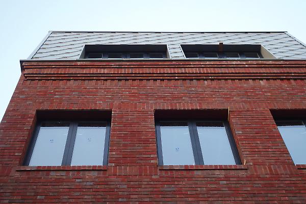 brick cornice and metal siding detail