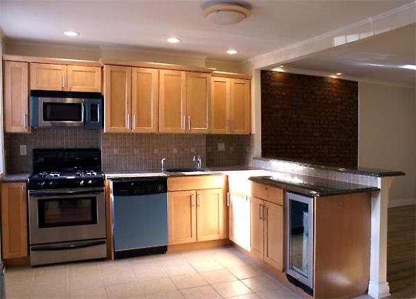 kitchen with exposed brick wall beyond