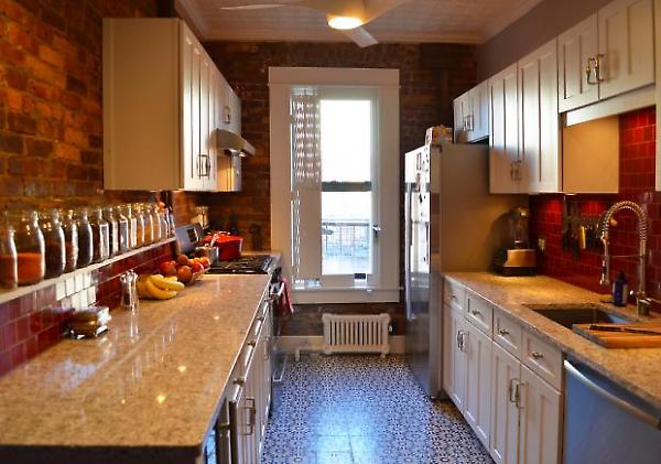 view of kitchen with exposed brick walls