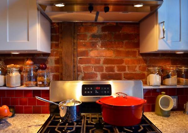 detail of tiled shelf and exposed brick wall