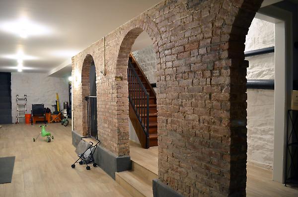 finished cellar with exposed brick arches