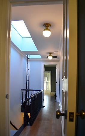 upper hallway with skylights